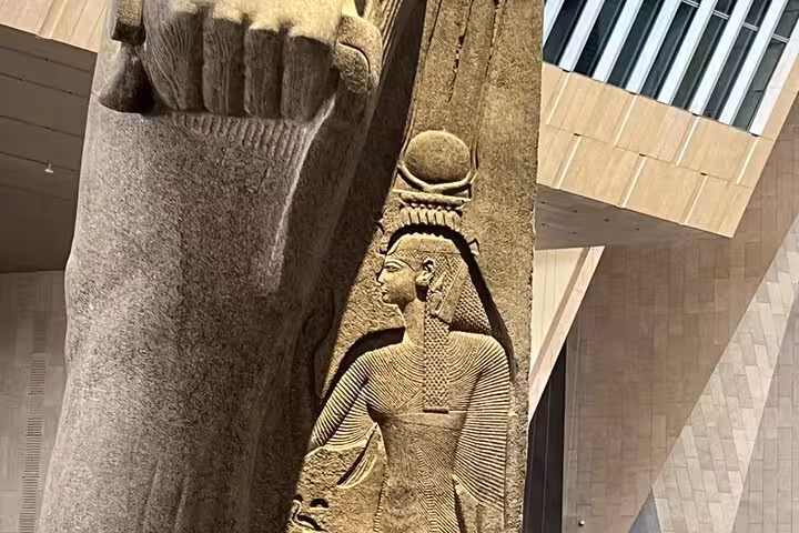 Close-up of carved pharaoh relief on colossal statue at Grand Egyptian Museum Cairo private tour