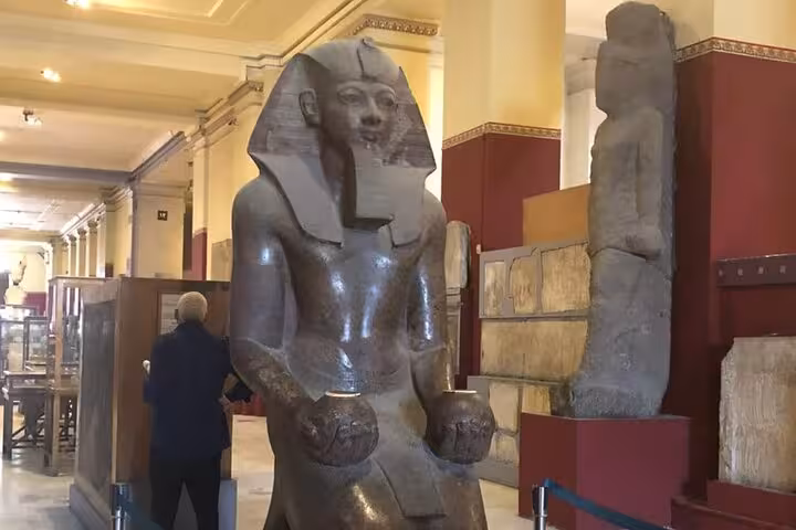 Colossal seated pharaoh statue inside the Egyptian Museum Cairo, must-see stop on a private Giza tour