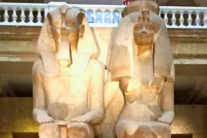 Colossal seated pharaoh statues inside Egyptian Museum Cairo on private Giza Pyramids and bazaar tour