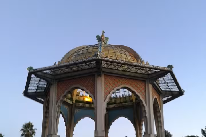 Majestic pavilion with ornate dome stands against a clear sky in the heart of Piazza Armerina, Sicily.