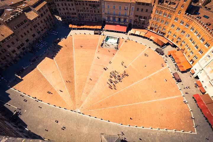 Aerial view of Piazza del Campo in Siena, a historic site known for its unique shell shape and architecture.