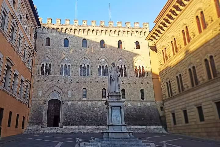 Historic Piazza Salimbeni in Siena with medieval palazzo and statue, a cultural stop on the Tuscany Chianti Brunello tour