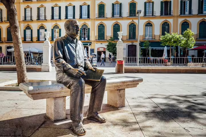 Bronze statue of Picasso sitting on a bench in Plaza de la Merced, Málaga, Spain