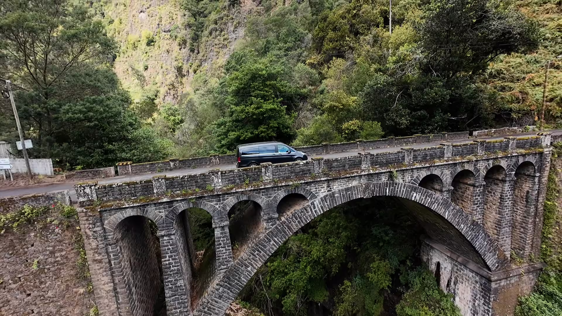 Scenic stone bridge on Pico do Arieiro tour, showcasing lush Madeira landscapes and adventure with convenient pickup service.
