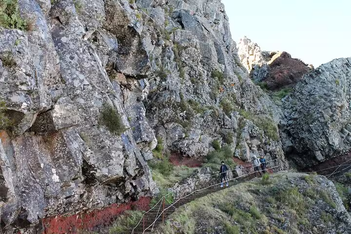 Hikers traverse rugged rocky trails at Pico do Arieiro, offering an exhilarating self-guided sunrise hike experience.