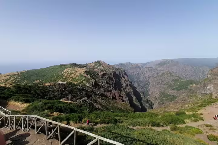 Breathtaking panorama of rugged cliffs and green landscapes from Pico Ruivo, a top-rated hiking destination in Madeira.