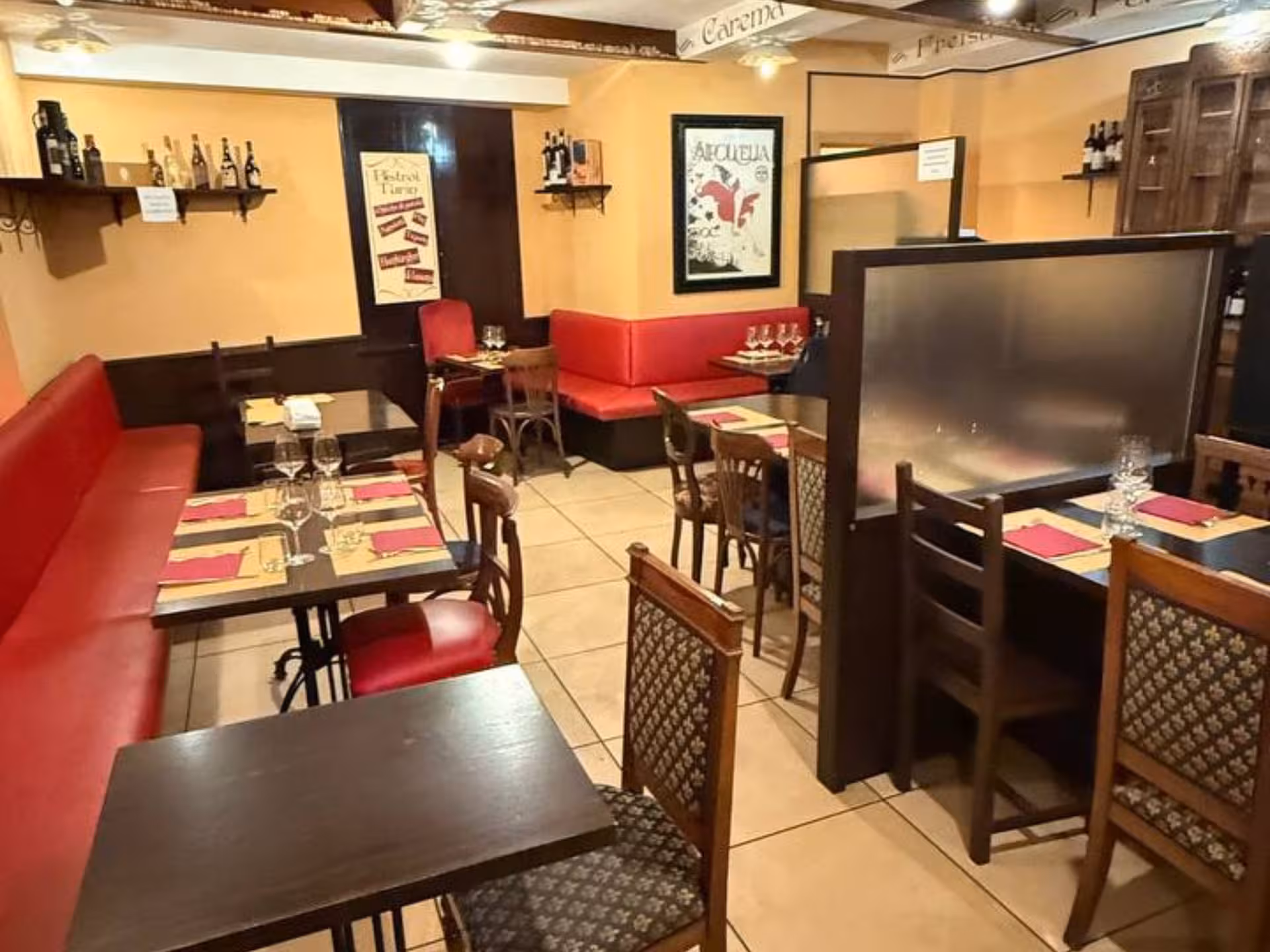 Charming Turin restaurant interior with red seating, set for Piedmontese tapas and wine tasting.