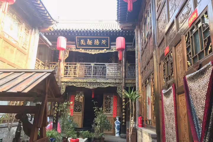 Traditional Chinese courtyard in Pingyao, featuring intricate woodwork and red lanterns on a private Beijing to Xian tour.