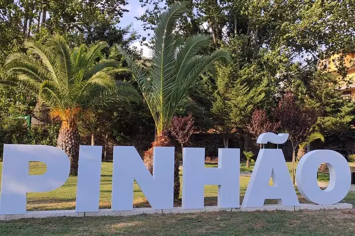 Large Pinhão sign in a green riverside park, Douro Valley Portugal landmark for Visit Pinhão tour