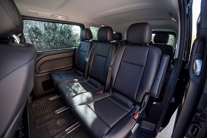 Comfortable leather rear seats in private van for Piraeus port to Athens hotel arrival transfer in Greece