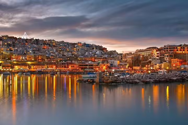 Piraeus harbor at sunset with waterfront lights, scenic stop on a Best of Athens half day private tour