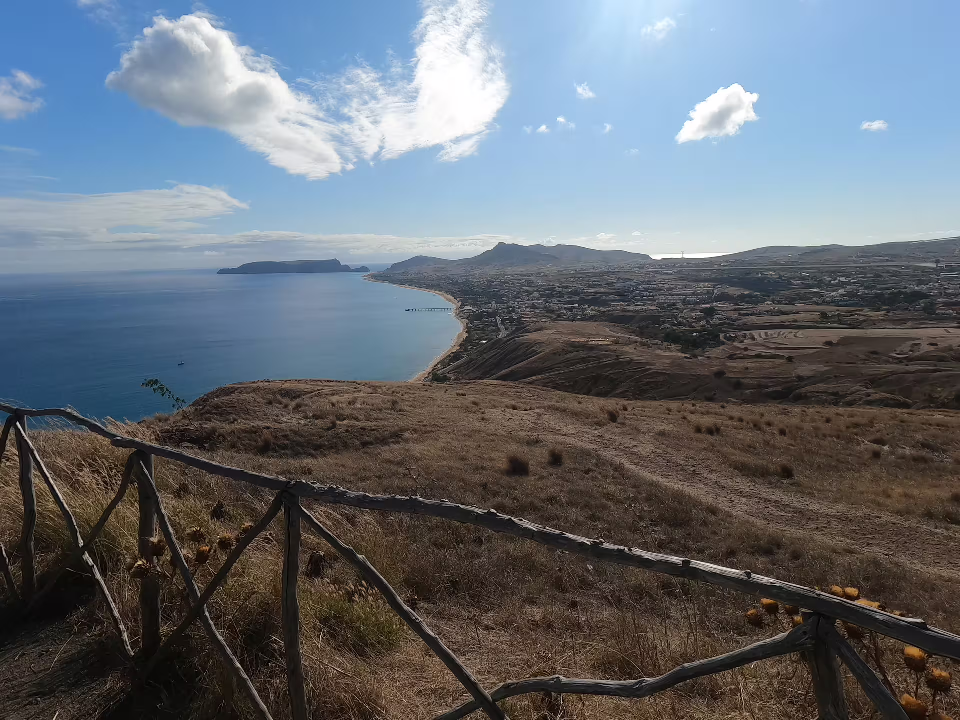 Scenic island coastline view with rugged cliffs and clear blue sea, perfect for the Pirate Expedition Full Island Tour adventure.