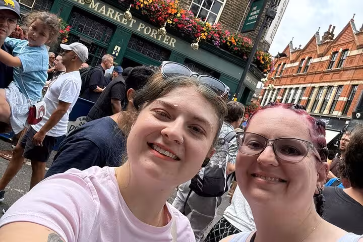 Two smiling women taking a selfie near the Market Porter pub during a Pirate Walking Tour in Southwark London