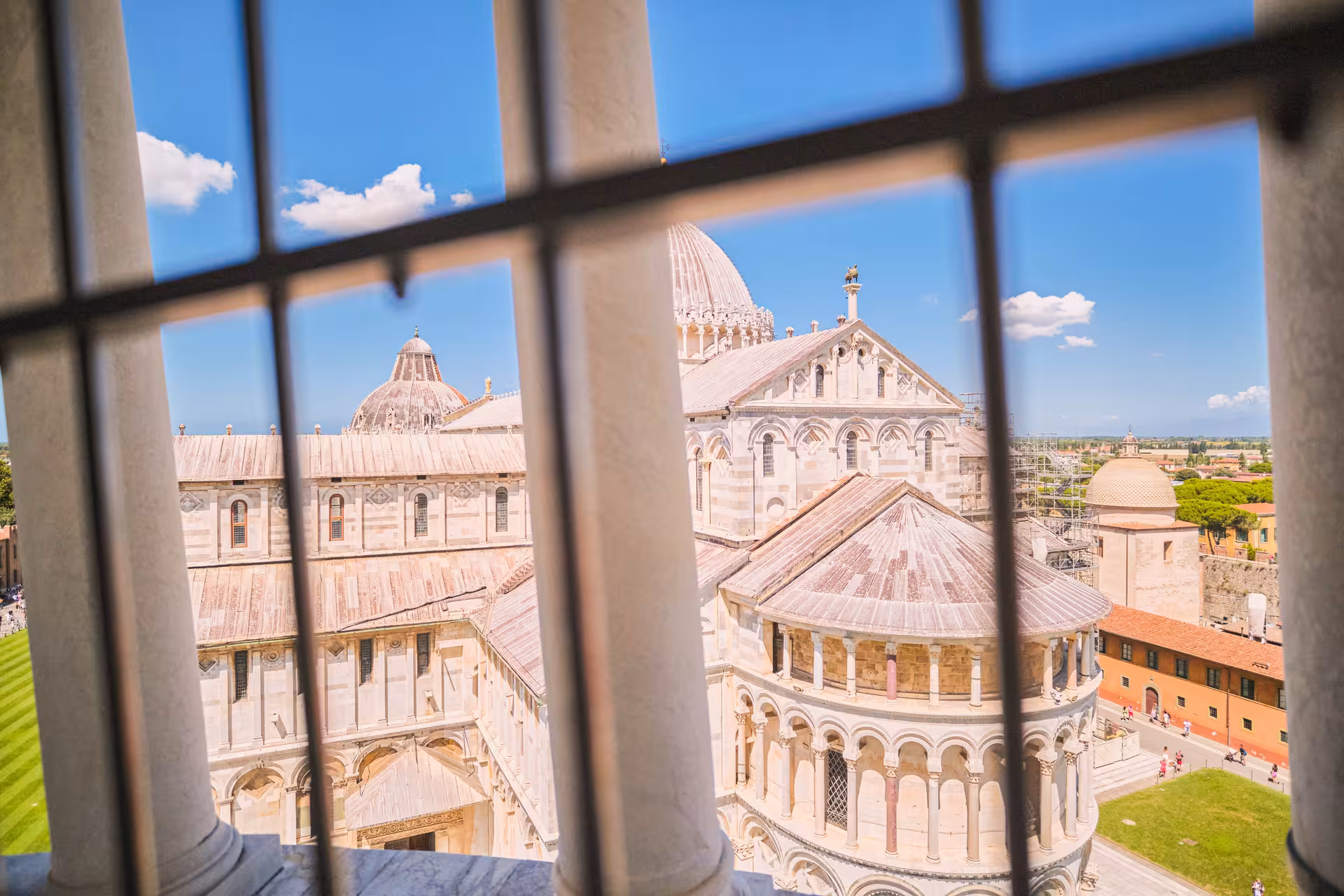 View of Pisa Cathedral through columns on a sunny day during a private tour from Florence.