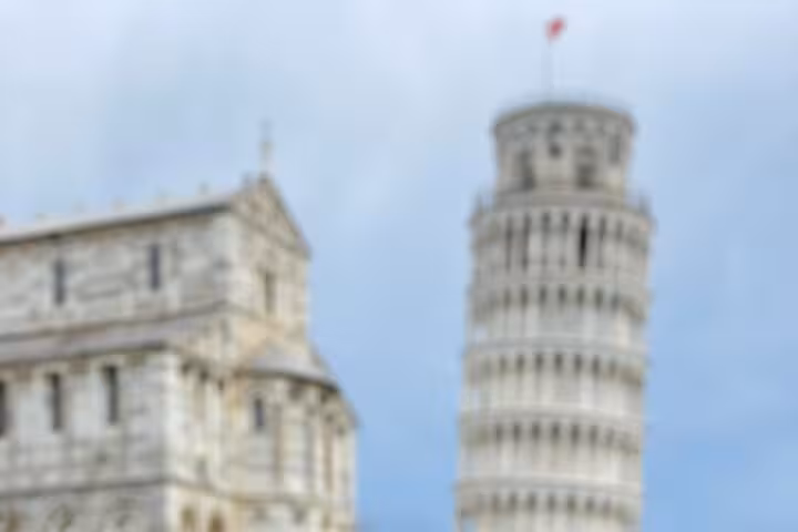 Blurry view of Pisa's Leaning Tower and Cathedral, highlighting iconic landmarks on a Florence day trip.