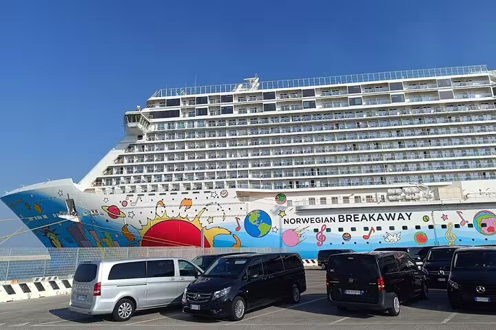 Norwegian Breakaway cruise ship docked at La Spezia port with vans ready for Pisa and Lucca private tour and wine-tasting
