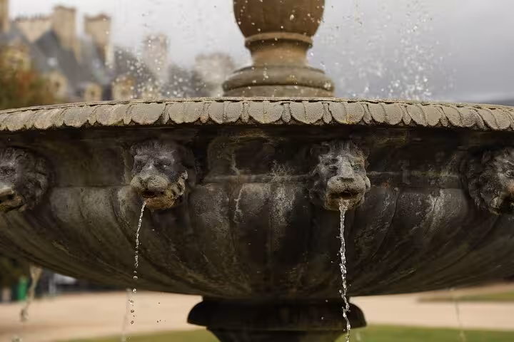 Close-up of Place des Vosges stone fountain spouts in Le Marais, Paris on a private guided walking tour