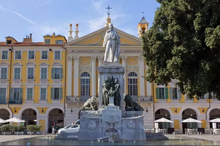 Place Garibaldi fountain with statue and yellow baroque buildings in Nice, France