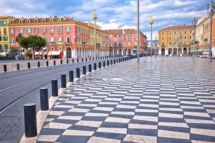 Place Masséna in Nice with black and white checkered marble pavement and colorful baroque buildings