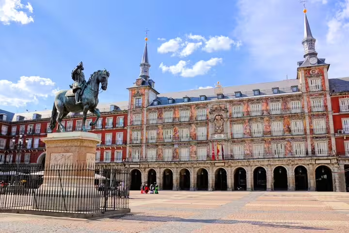 Plaza Mayor Madrid with equestrian statue of King Philip III and ornate red baroque building