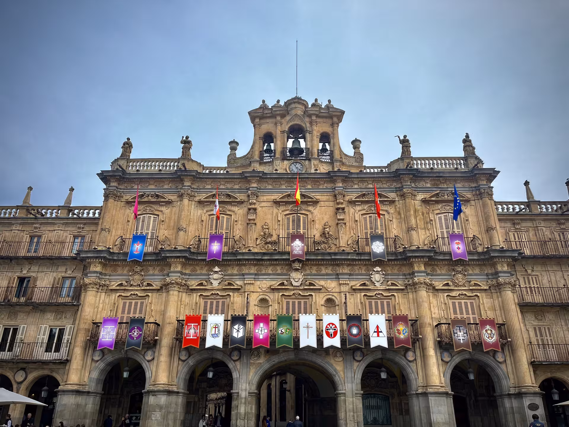 Plaza Mayor Salamanca facade with banners and arches, highlight of Encantos Locales + Palacio Monterrey tour