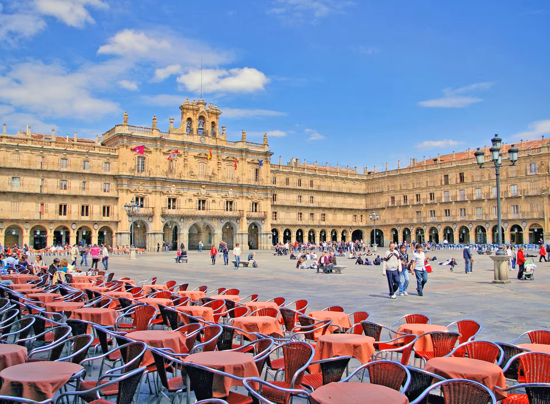 Bustling Plaza Mayor in Salamanca, Spain with outdoor cafes and historic architecture, perfect for cultural exploration.