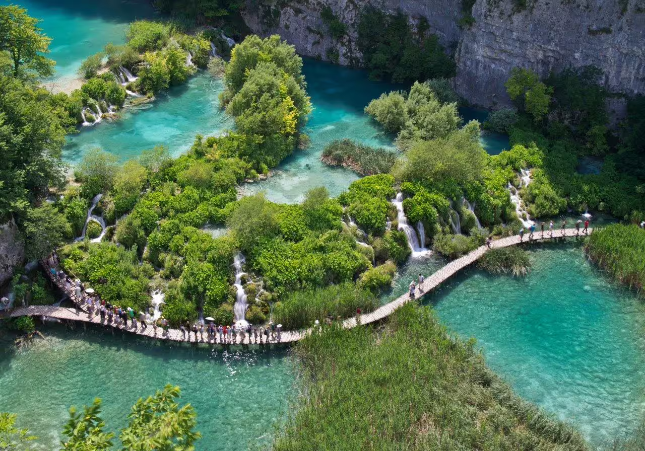 Plitvice Lakes boardwalk over turquoise waterfalls and pools, must-see nature day trip on Croatia self-drive