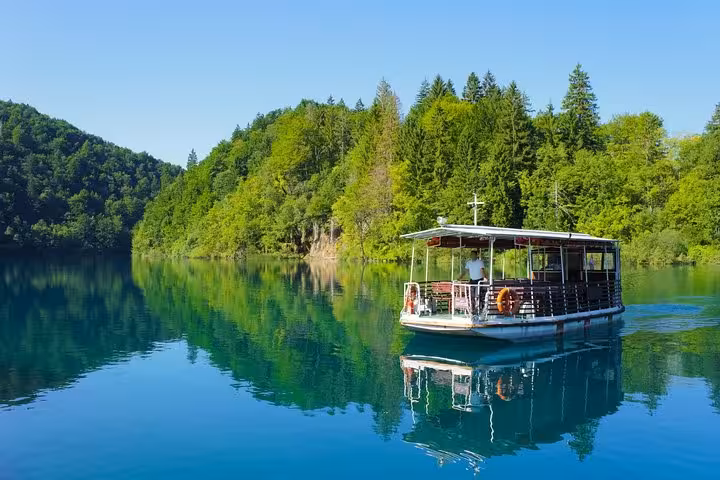 Boat cruise on Plitvice Lakes National Park, Croatia, tranquil turquoise water on 3-day Zagreb and Slovenia tour