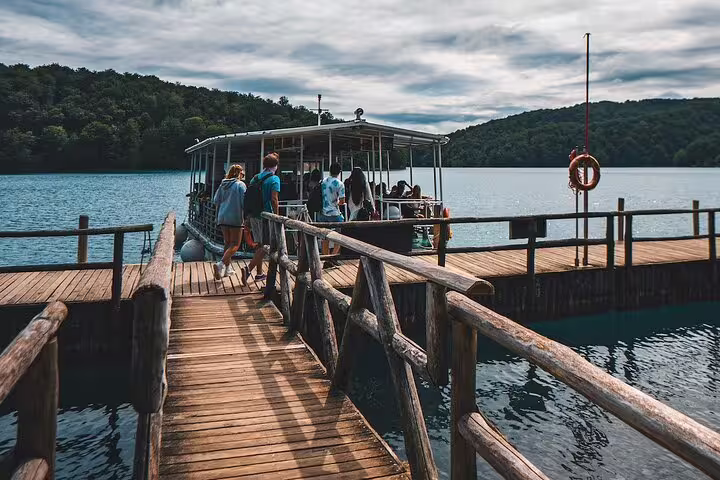 Visitors boarding scenic lake boat at Plitvice Lakes National Park on a scheduled guided tour in Croatia