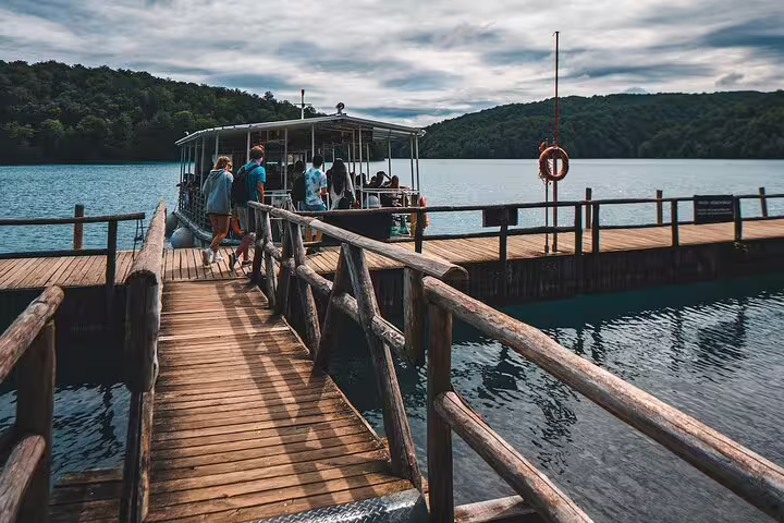 Visitors boarding the electric boat at Plitvice Lakes National Park on a scheduled economy day tour
