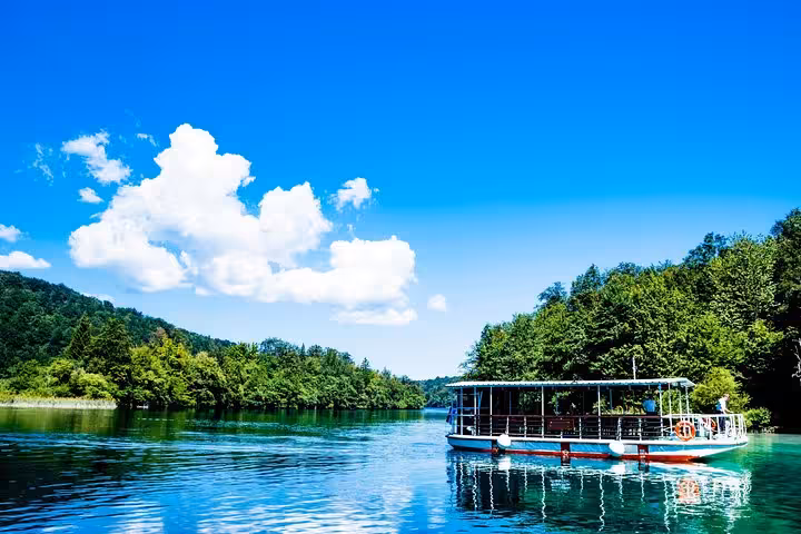 Electric boat on Plitvice Lakes National Park turquoise water, highlight of Zagreb to Zadar private day tour