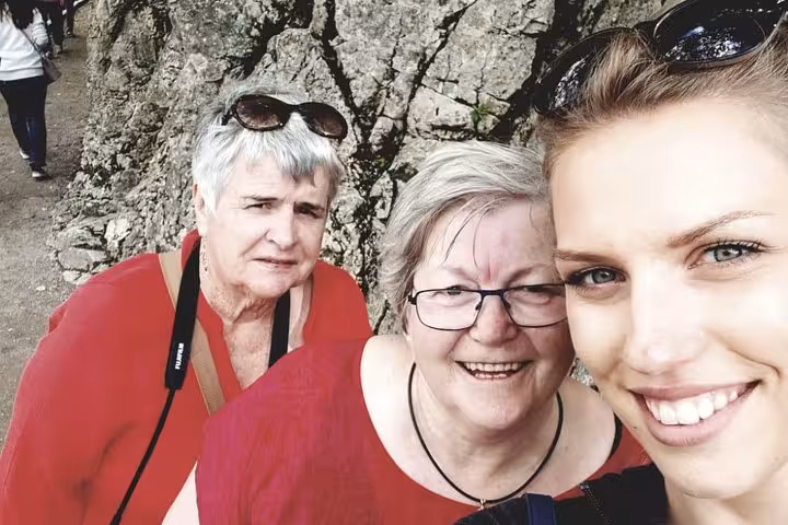 Group selfie on rocky trail in Plitvice Lakes National Park during private Zagreb to Plitvice and Rastoke tour