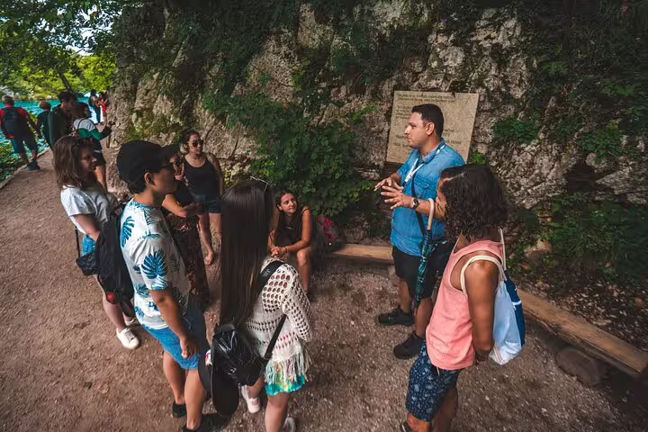 Tour guide explaining the route to visitors at Plitvice Lakes National Park on a scheduled guided tour