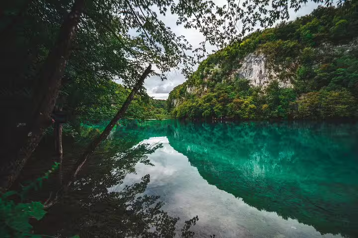 Turquoise lake reflections and limestone cliffs at Plitvice Lakes National Park on a guided tour in Croatia