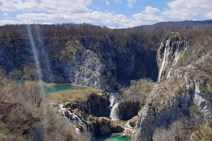 Panoramic Plitvice Lakes viewpoint with cliffs, cascades and boardwalk, highlight of private tour from Zagreb