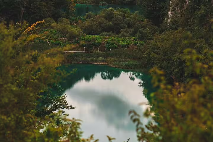 Panoramic view of turquoise Plitvice Lakes surrounded by forest, ideal for scheduled economy tour in Croatia