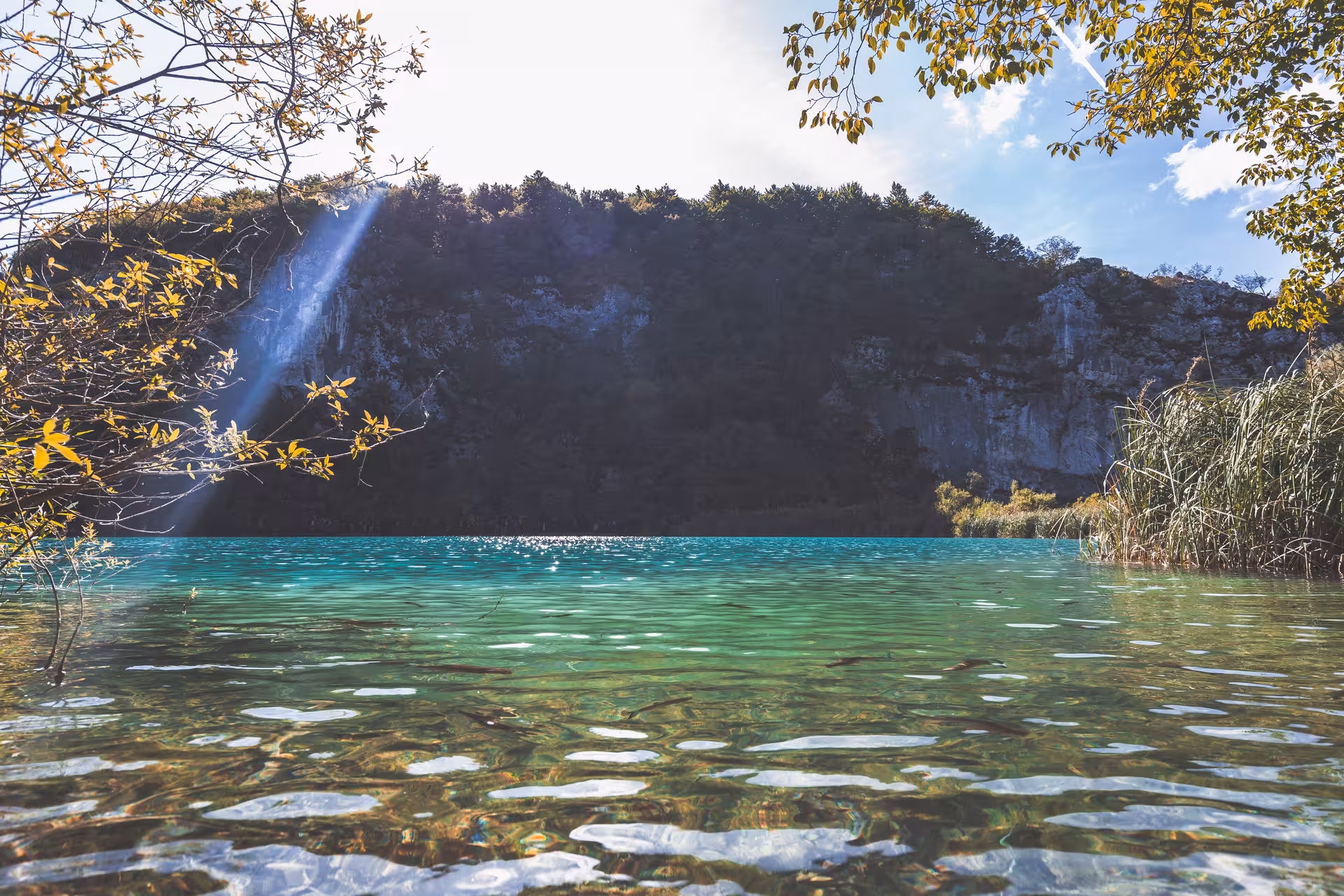 Turquoise lake and sunlit cliffs at Plitvice Lakes, a hidden gems day trip from Zagreb, Croatia
