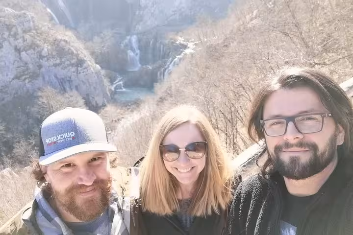 Travelers selfie with Plitvice Lakes waterfalls viewpoint on From Zagreb private tour to Plitvice and Rastoke
