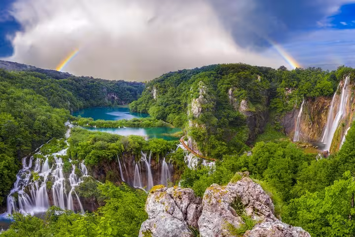 Panoramic Plitvice Lakes waterfalls and turquoise pools with rainbow, highlight on Zagreb to Split private tour