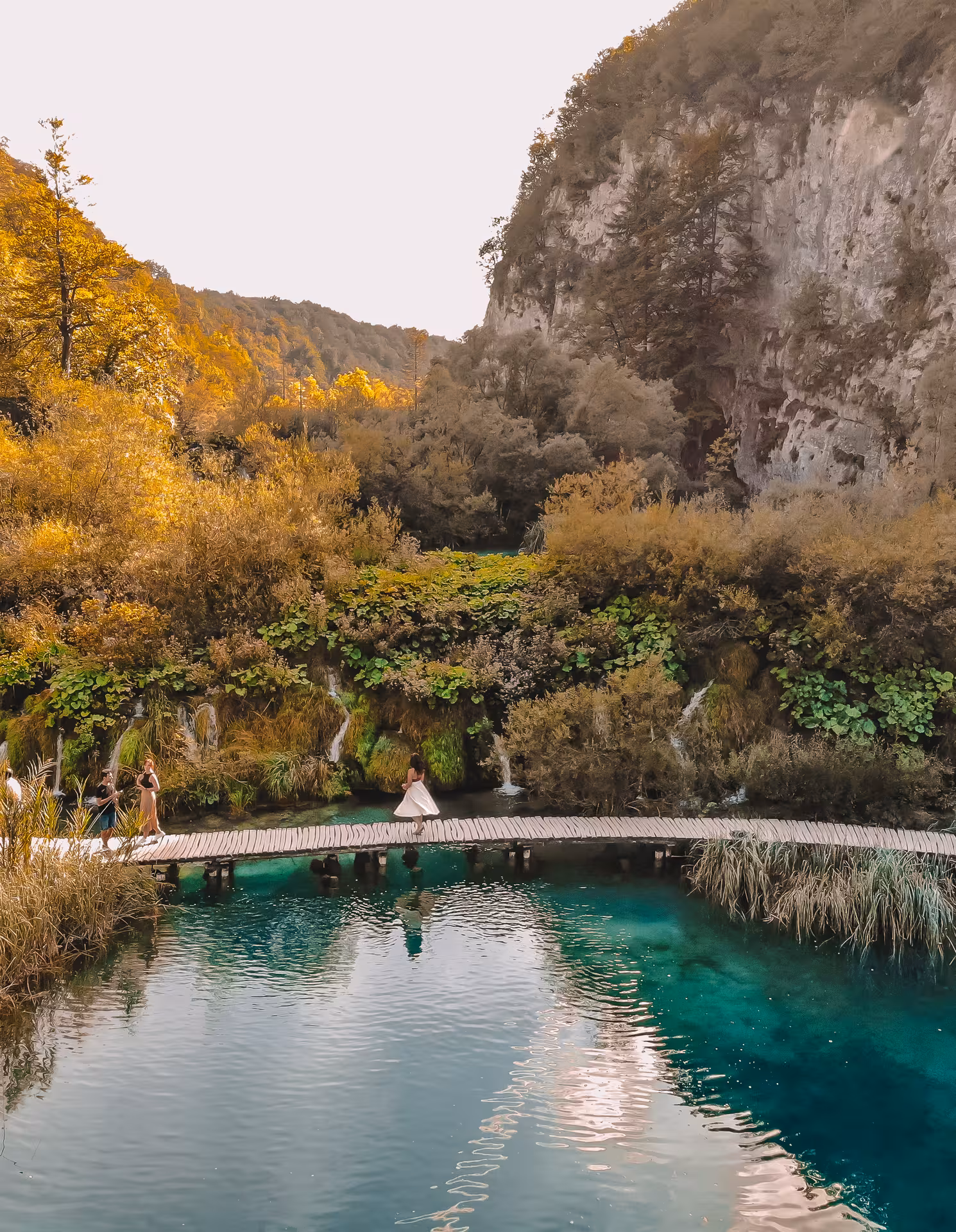 Wooden boardwalk over emerald water at Plitvice Lakes National Park, hidden gems from Zagreb day tour