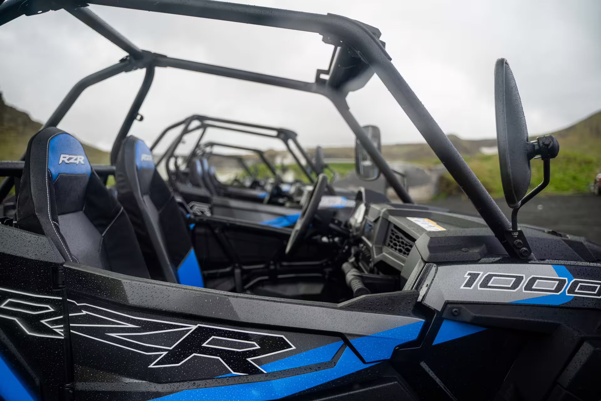 Polaris RZR 1000 buggy interior with blue seats and roll cage on Iceland lava field tour