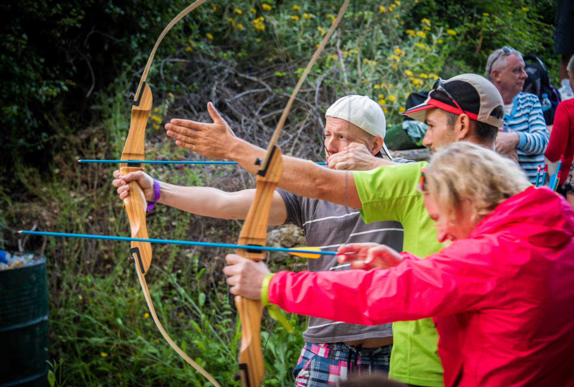 Visitors try archery during the Polylimnio Waterfalls hiking tour in Messinia, Peloponnese outdoor activity