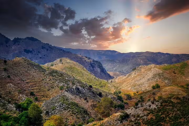 Stunning sunset over the scenic mountains of Polyrrinia, ideal for a private hiking tour in Sirikari Gorge.