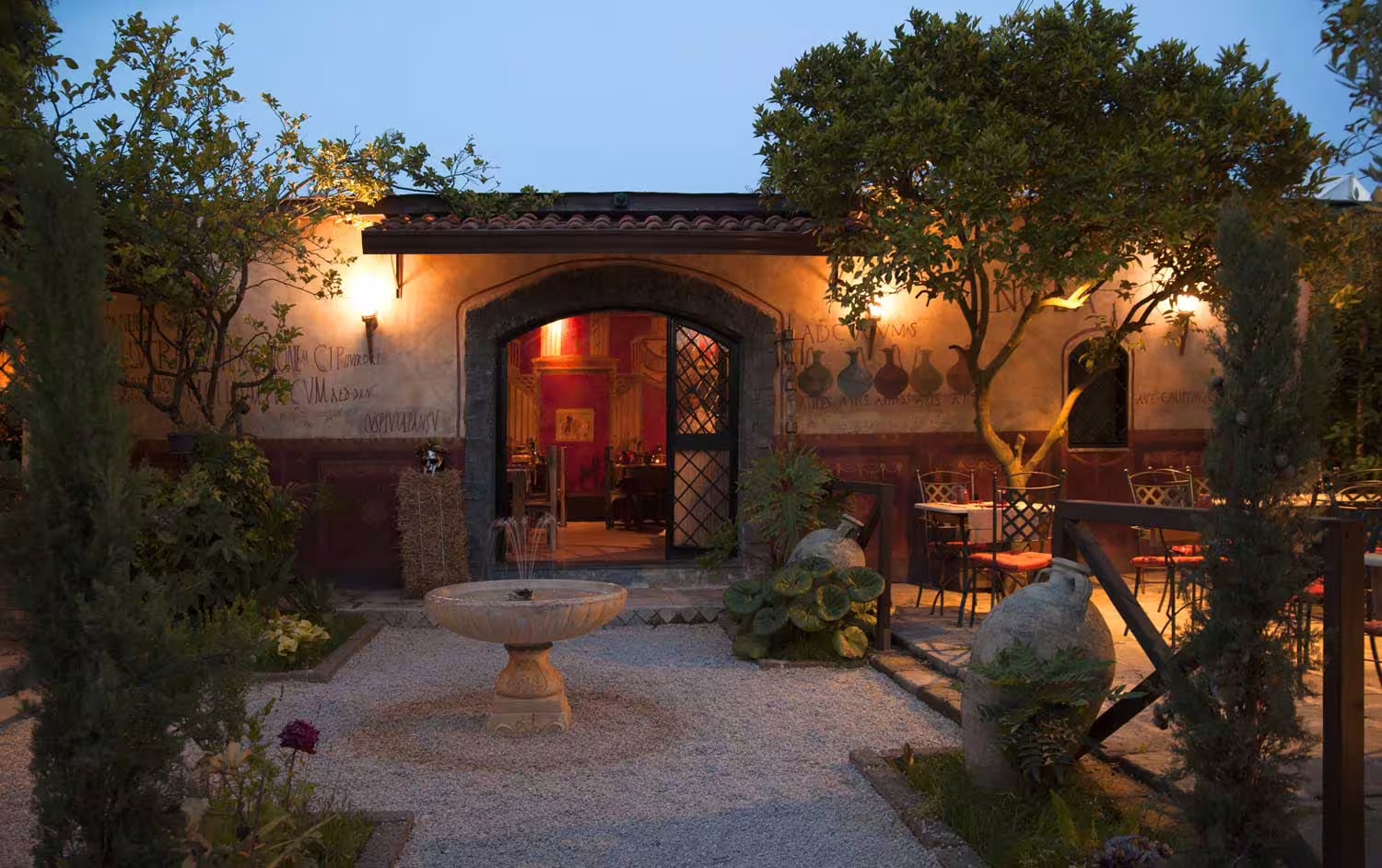 Charming courtyard restaurant near Pompeii ruins with fountain and lantern-lit terrace for immersive ancient Roman lunch