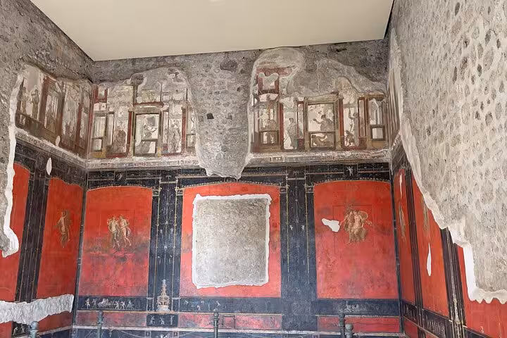 Explore ancient Pompeii with vibrant frescoes on a skip-the-line small group tour, showcasing Roman art and history.