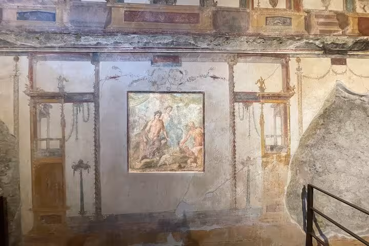 Intricate frescoes on ancient walls in Pompeii, showcasing Roman art during the Semi-Private Tour from Positano.