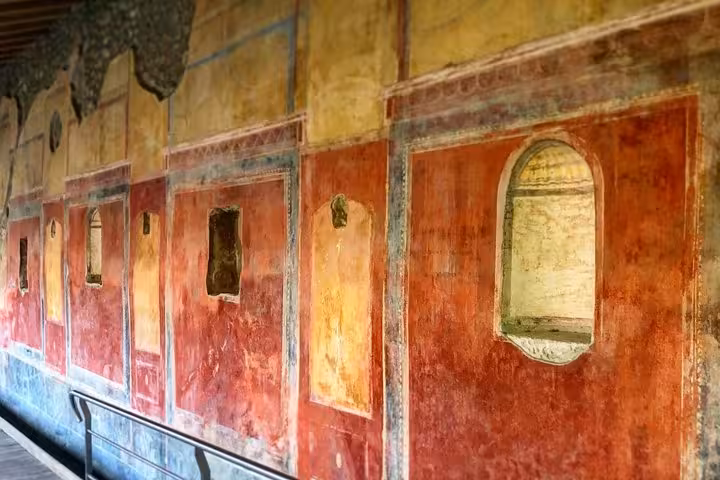 Vibrant frescoes depicting ancient Roman art at Pompeii on a guided tour from the Amalfi Coast.