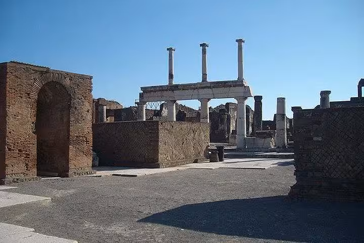 View of Pompeii's ancient ruins with towering columns, offering a glimpse into Roman history on the guided tour.