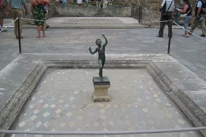 Bronze statue fountain in Pompeii courtyard seen on VIP small-group guided tour of ruins