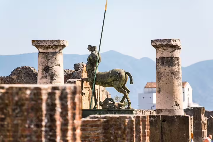 Iconic centaur statue amidst ancient ruins in Pompeii, a highlight of the guided Skip The Line tour.